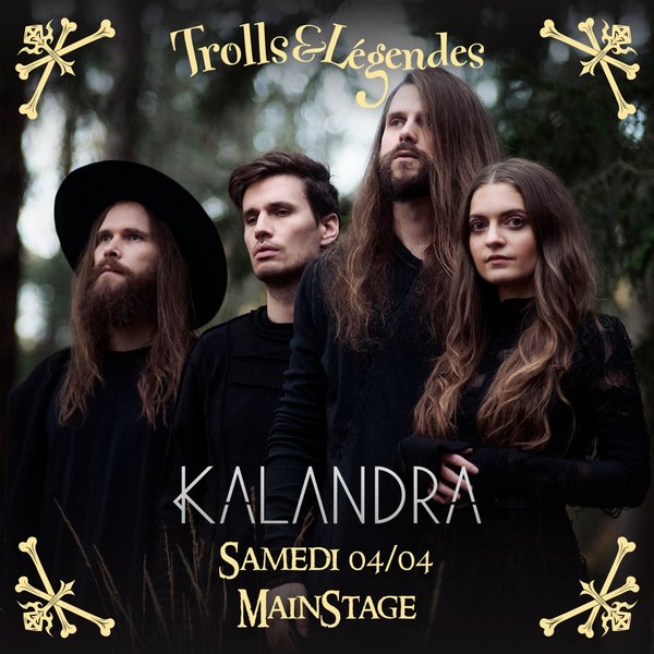 Kalandra - Four musicians with long hair pose, dressed in black, in a forest.
