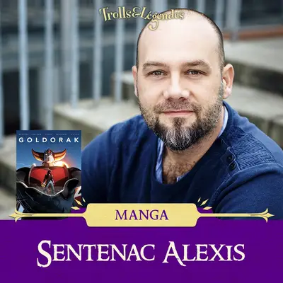 Alexis SENTENAC - Homme souriant avec une barbe, en t-shirt bleu, avec un visuel de Goldorak à gauche.