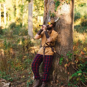 Bardix le Gaulois - Homme mystérieux jouant de la flûte sous un arbre dans la forêt