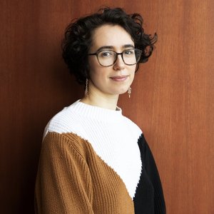 Fanny CALDIN - Portrait d'une jeune femme au style contemporain et aux cheveux bouclés.